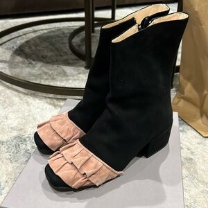 Racine Carree black suede zip bootie with pinkish suede ruffle on toe